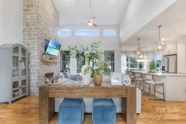 a dining room with furniture potted plants and wooden floor