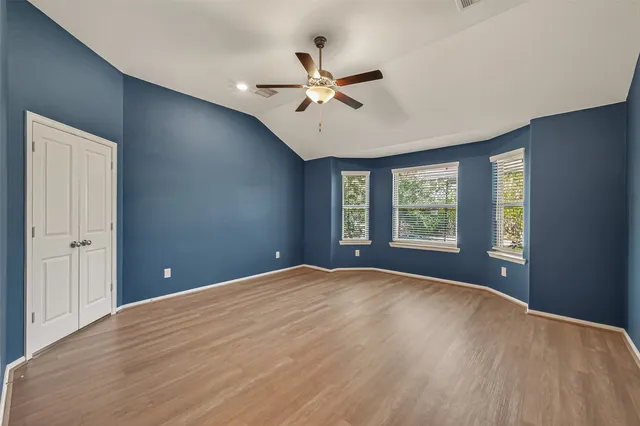a view of an empty room with a ceiling fan