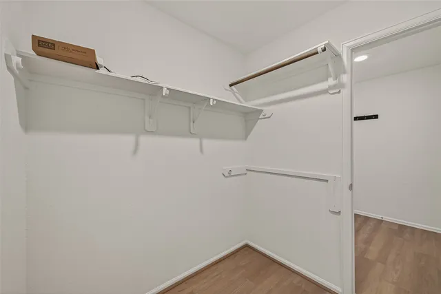 a kitchen with a sink and wooden floor