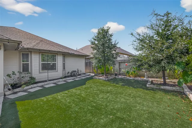 a view of a house with a yard and sitting area
