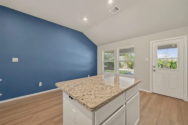 a kitchen with sink cabinets and wooden floor