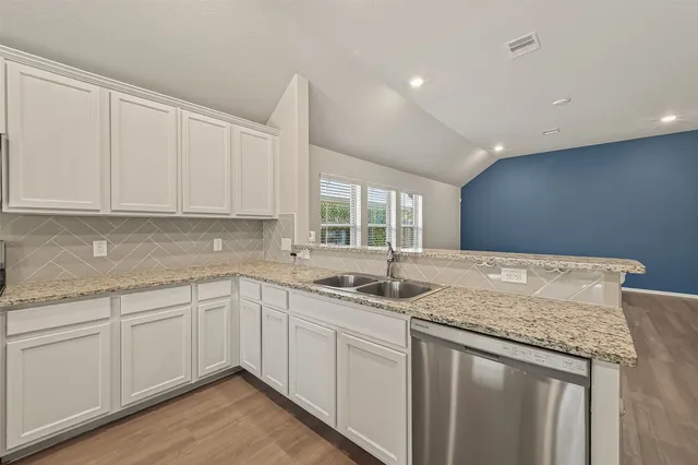 a kitchen with a sink stove top oven and refrigerator