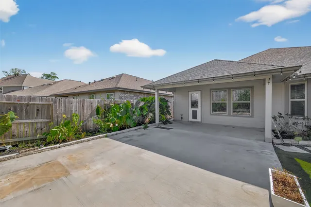 a view of a house with a yard and potted plants