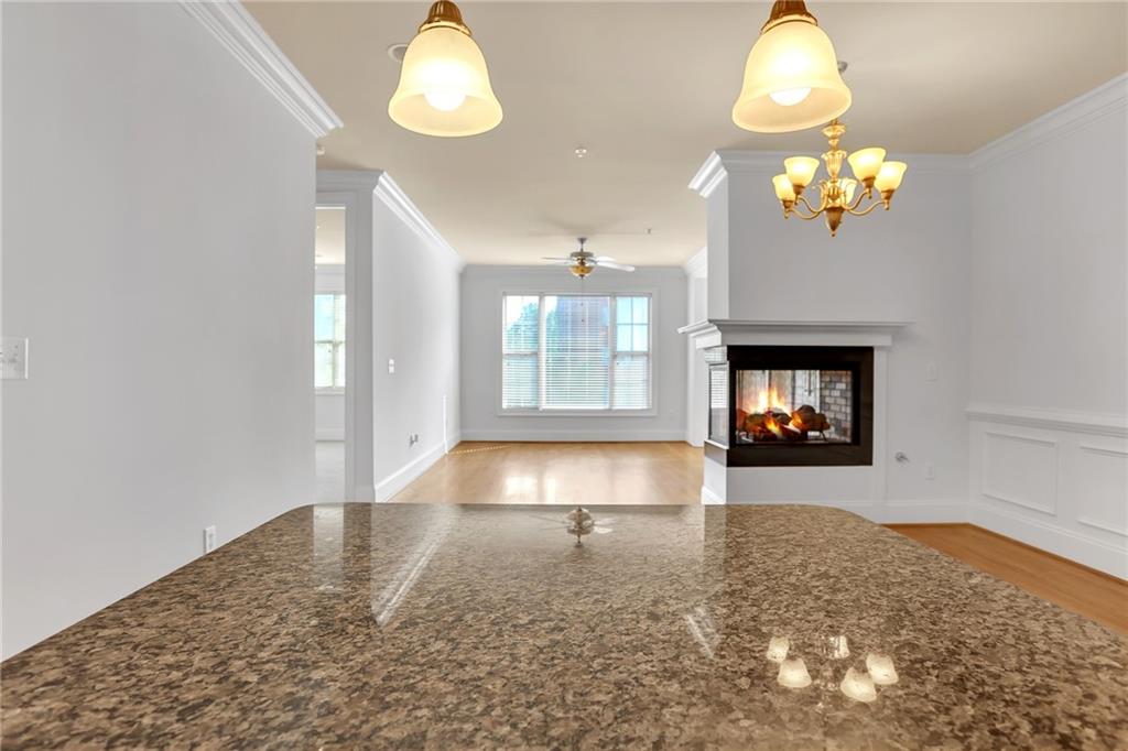 2300 Peachford Road, Unit 1209 Atlanta, GA 30338 - Photo 11 of 31 a view of a room with a fireplace chandelier fan and windows