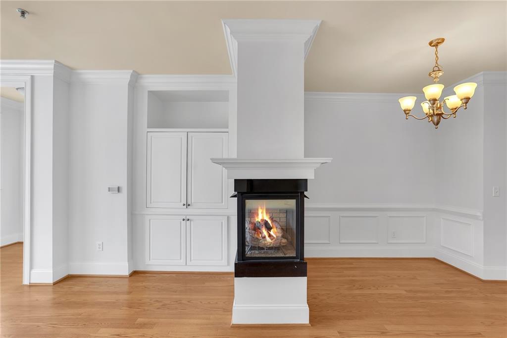 2300 Peachford Road, Unit 1209 Atlanta, GA 30338 - Photo 15 of 31 a view of a livingroom with wooden floor and a fireplace