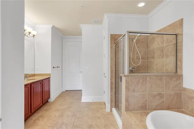 a bathroom with a sink vanity granite tub and a mirror