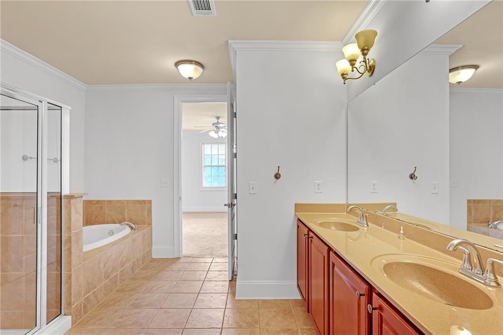 2300 Peachford Road, Unit 1209 Atlanta, GA 30338 - Photo 20 of 31 a bathroom with a sink vanity granite tub and a mirror