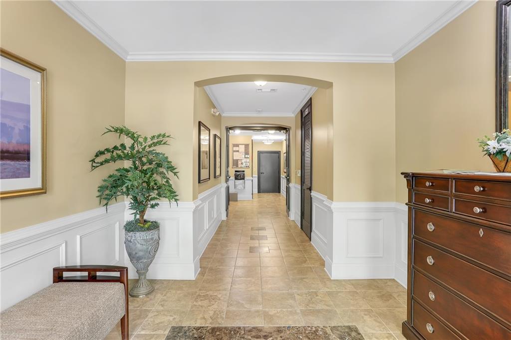 2300 Peachford Road, Unit 1209 Atlanta, GA 30338 - Photo 30 of 31 a hallway with a potted plant on the counter and mirror
