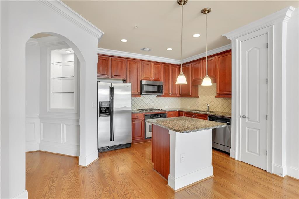 2300 Peachford Road, Unit 1209 Atlanta, GA 30338 - Photo 8 of 31 a kitchen with a refrigerator sink and cabinets