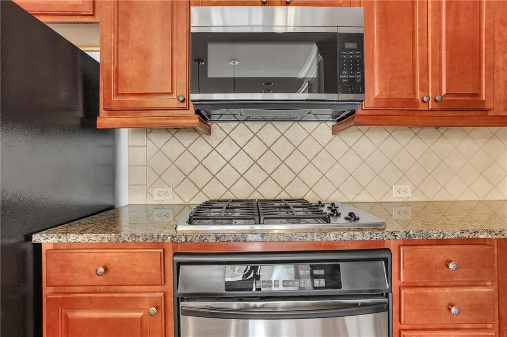 2300 Peachford Road, Unit 1209 Atlanta, GA 30338 - Photo 9 of 31 a stove top oven sitting inside of a kitchen