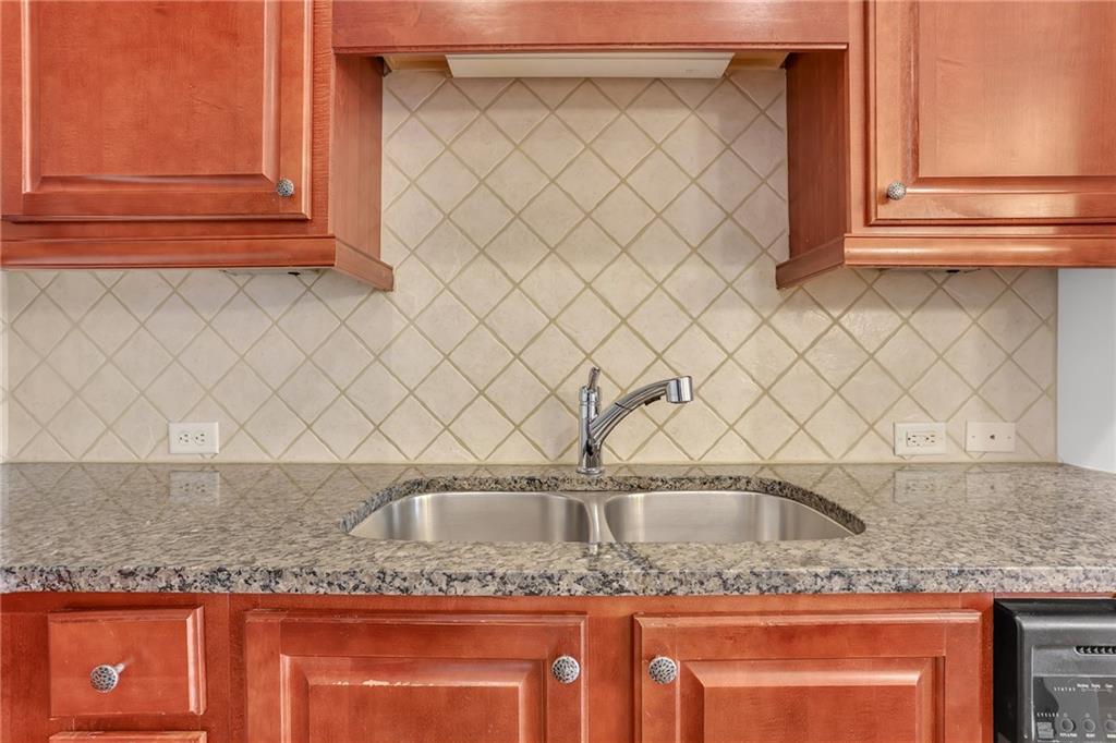 2300 Peachford Road, Unit 1209 Atlanta, GA 30338 - Photo 10 of 31 a kitchen with granite countertop a sink and a granite counter tops