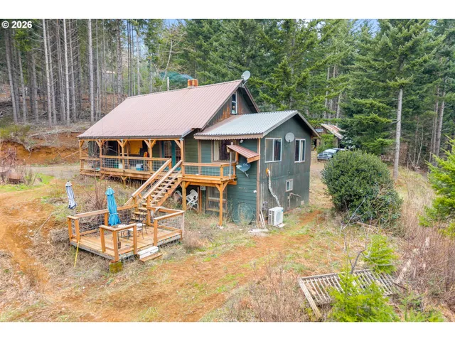 a view of a house with backyard porch and sitting area