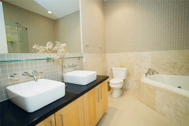 a bathroom with a sink a toilet and mirror