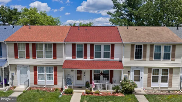 front view of a brick house with a yard