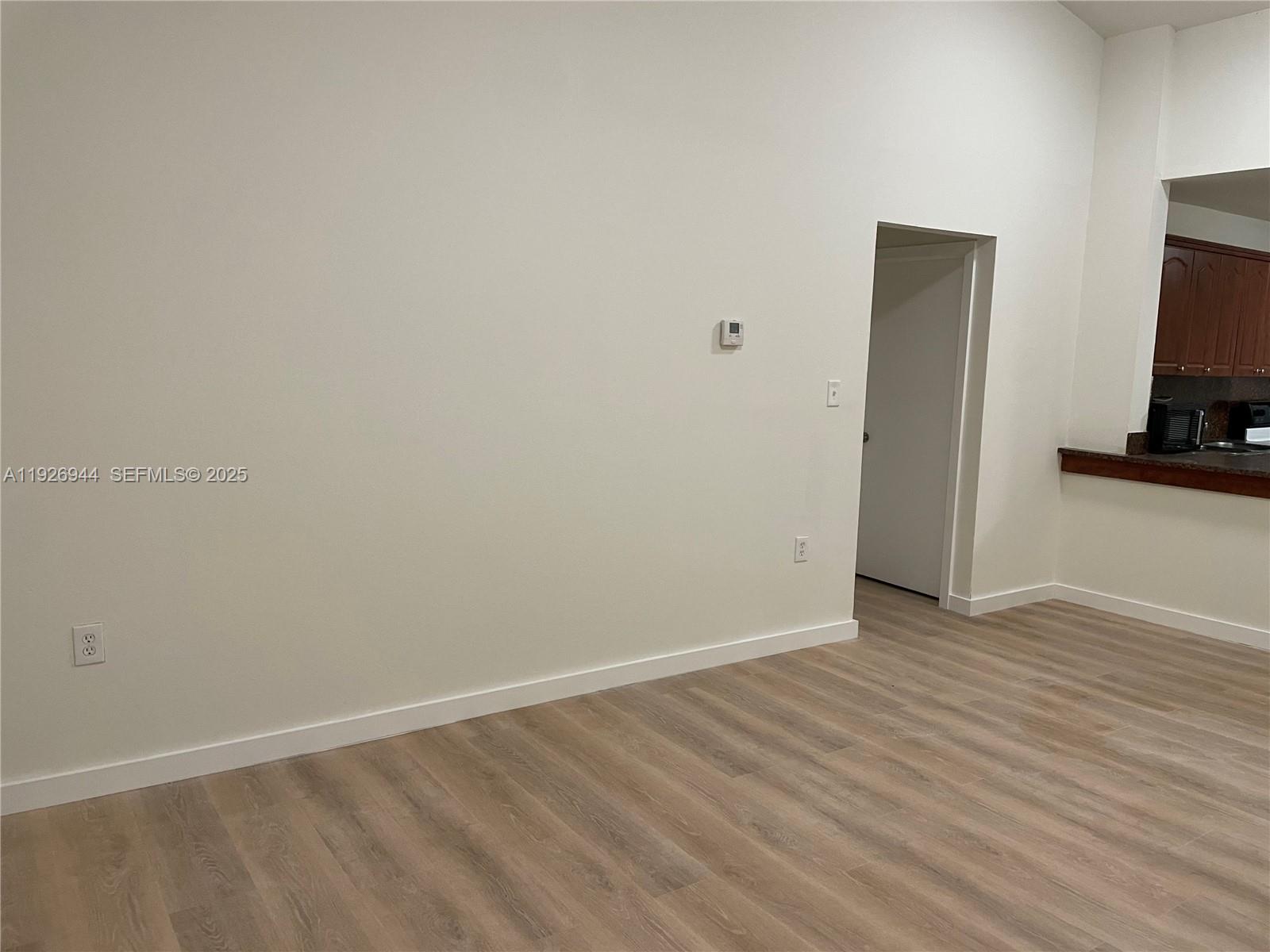 2179 Southwest 80th Terrace Miramar, FL 33025 - Photo 11 of 14 a view of an empty room with wooden floor and a flat screen tv