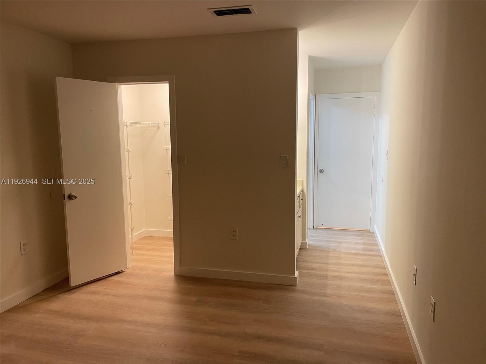 2179 Southwest 80th Terrace Miramar, FL 33025 - Photo 4 of 14 an empty room with wooden floor and a window