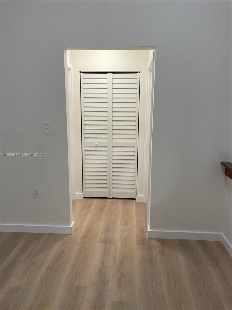 2179 Southwest 80th Terrace Miramar, FL 33025 - Photo 10 of 14 an empty room with wooden floor and windows