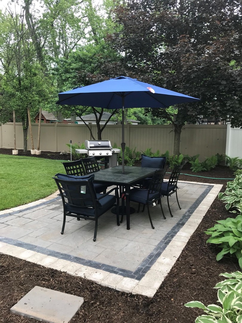 26-w068 Jewell Road Wheaton, IL 60187 - Photo 23 of 25 a view of backyard with outdoor seating a patio and a garden