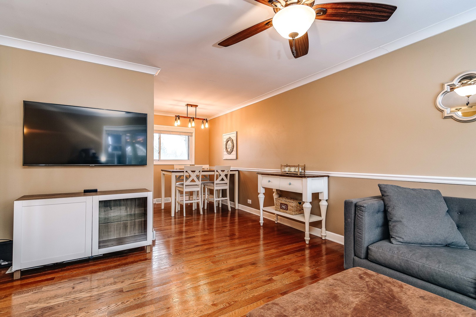 26-w068 Jewell Road Wheaton, IL 60187 - Photo 5 of 25 a living room with furniture wooden floor and a flat screen tv