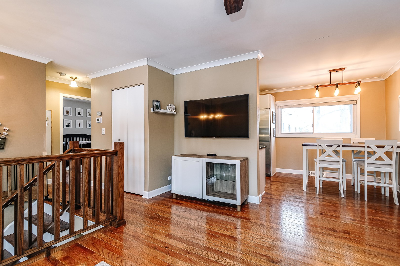 26-w068 Jewell Road Wheaton, IL 60187 - Photo 6 of 25 a living room with furniture wooden floor and a flat screen tv