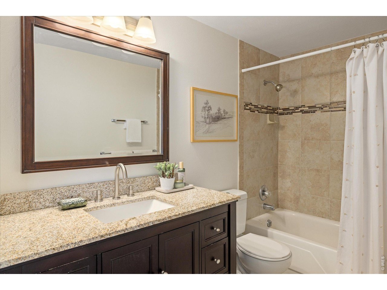 1850 Folsom Street, Unit 503 Boulder, CO 80302 - Photo 13 of 22 a bathroom with a granite countertop sink mirror and a