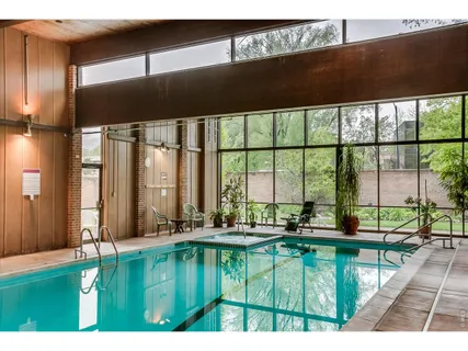 a living room with furniture and floor to ceiling window