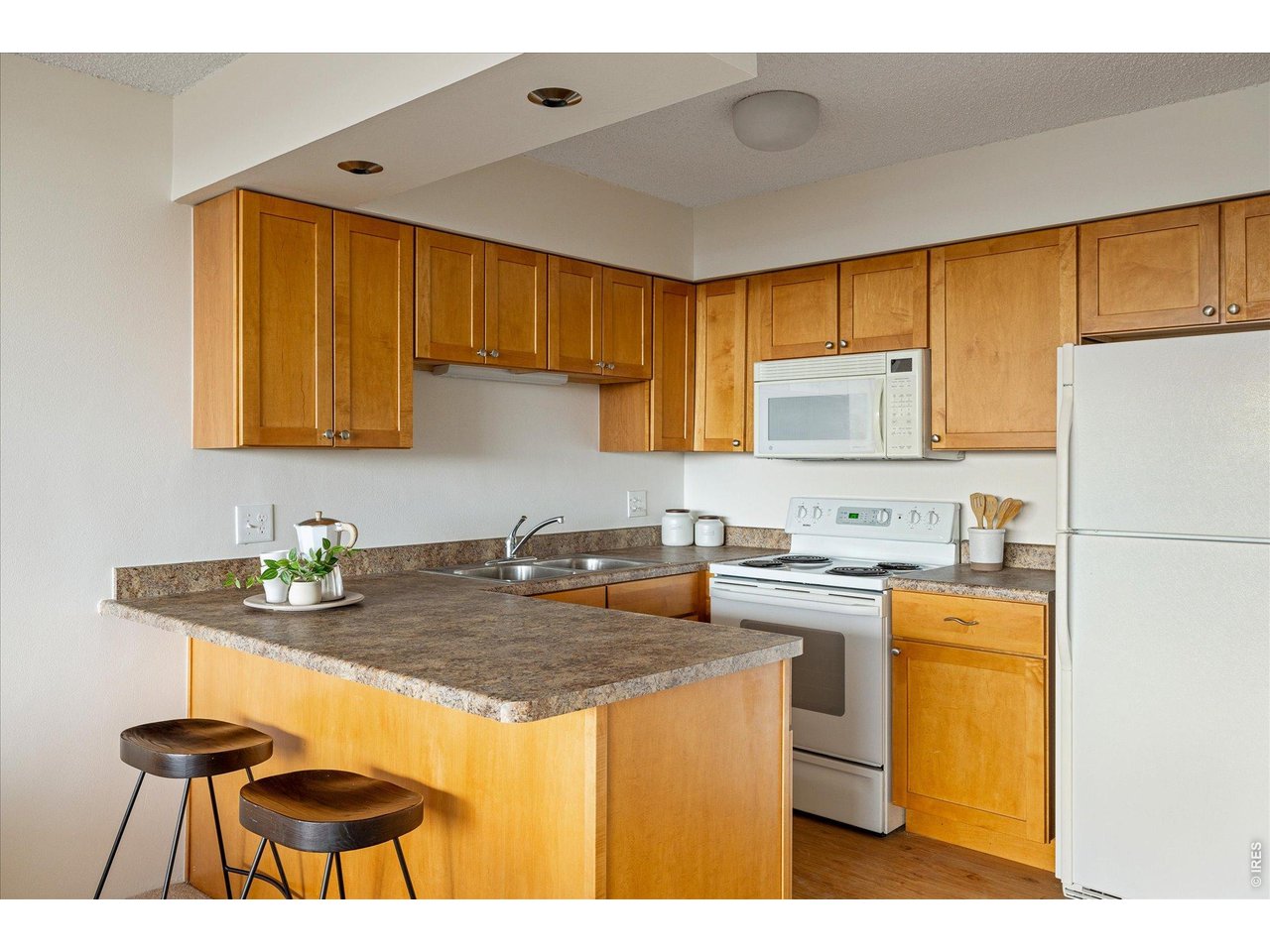 1850 Folsom Street, Unit 503 Boulder, CO 80302 - Photo 7 of 22 a kitchen with a sink a stove and cabinets