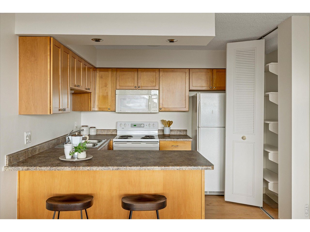 1850 Folsom Street, Unit 503 Boulder, CO 80302 - Photo 10 of 22 a kitchen with stainless steel appliances granite countertop a sink stove and refrigerator
