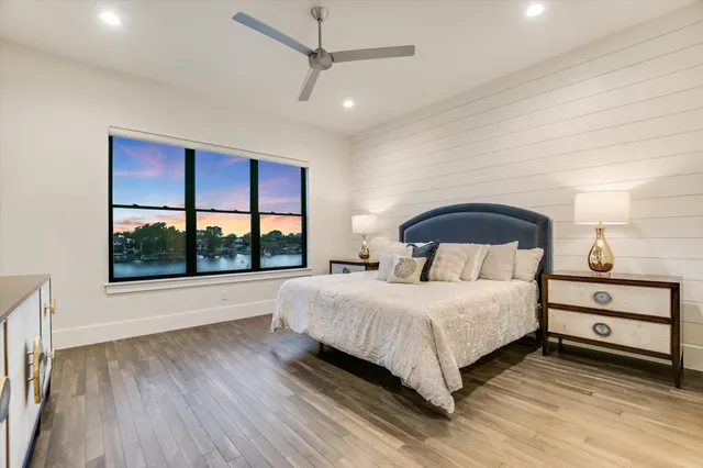 a bedroom with a bed and a large window