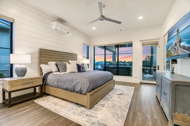 a bedroom with a large bed and a large window