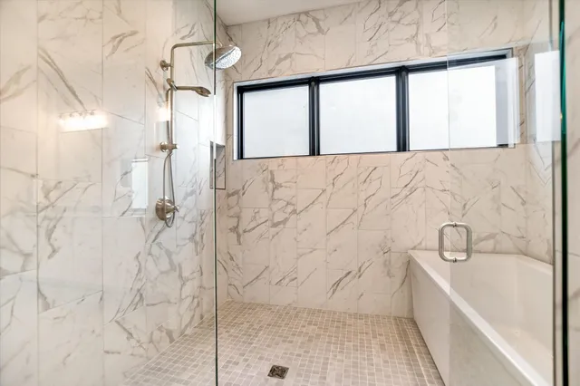 a bathroom with a bathtub and a shower