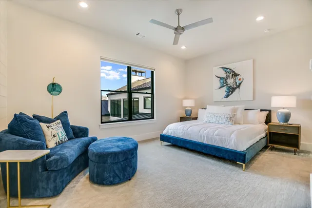 a bedroom with a bed a dresser and chair