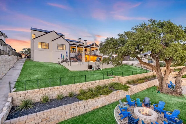 a backyard of a house with barbeque oven table and chairs