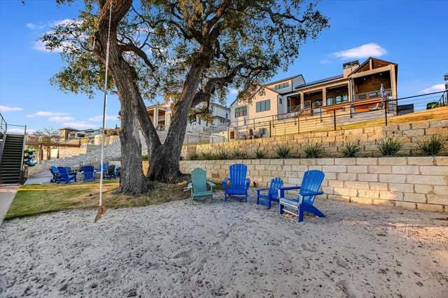 a aerial view of a house with swimming pool and a chairs
