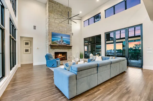 a living room with fireplace furniture and a large window