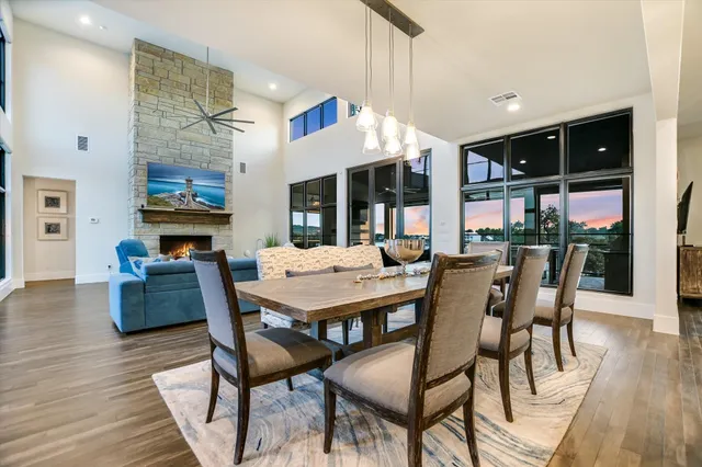 a dining area with furniture a rug and wooden floor