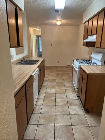 a kitchen with a stove top oven sink and cabinets