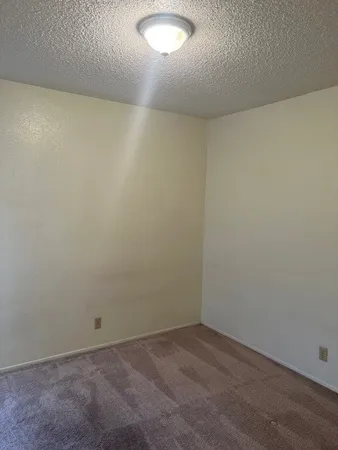an empty room with a empty space and a window