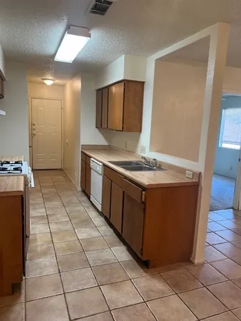 a kitchen with stainless steel appliances granite countertop a stove a sink and a refrigerator