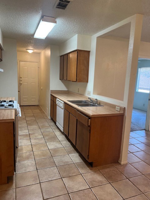 112 Verna Spur, Unit B Georgetown, TX 78628 - Photo 7 of 23 a kitchen with stainless steel appliances granite countertop a stove a sink and a refrigerator