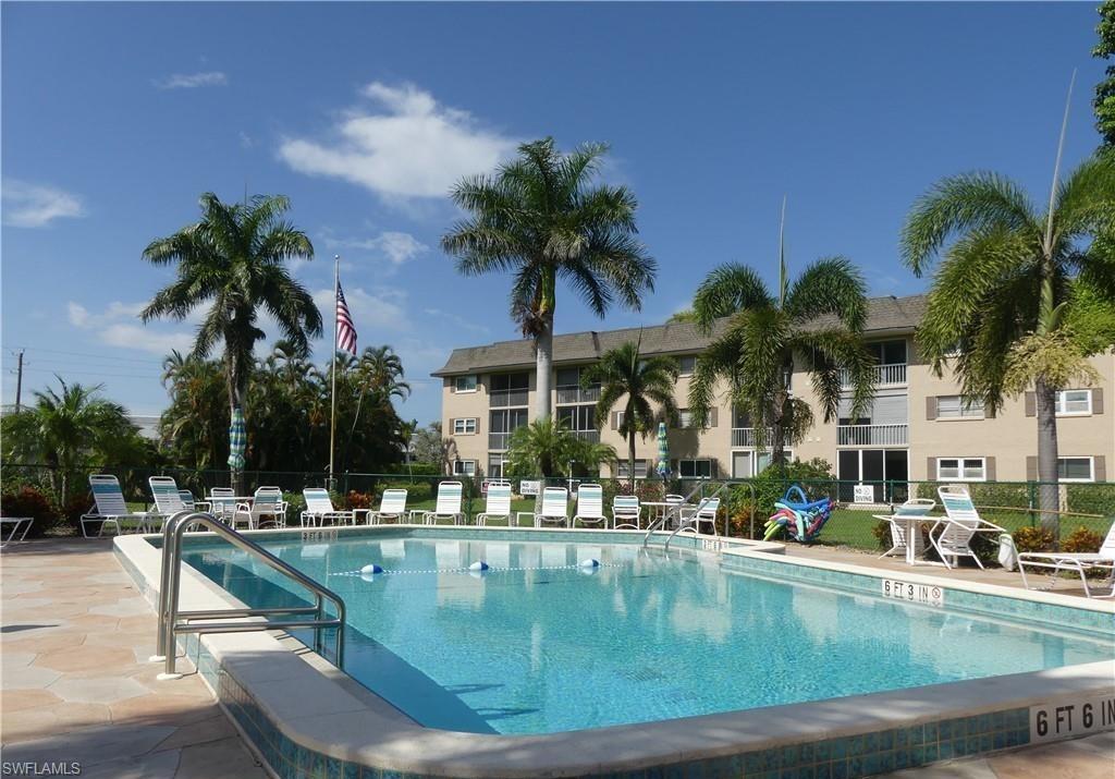5499 Rattlesnake Hamm Road, Unit A207 Naples, FL 34113 - Photo 28 of 32 a view of outdoor space with swimming pool and lounge chair