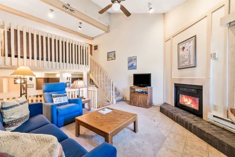 a living room with furniture fireplace and flat screen tv