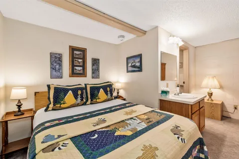 a bedroom with a bed and a table in it