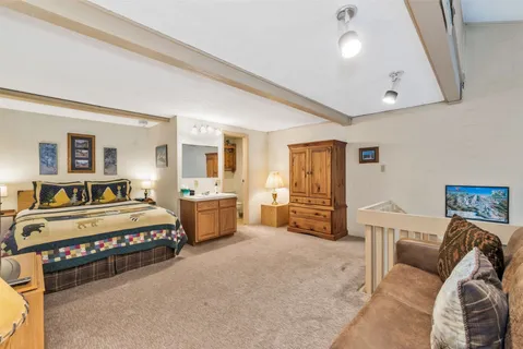 a spacious bedroom with a bed and furniture