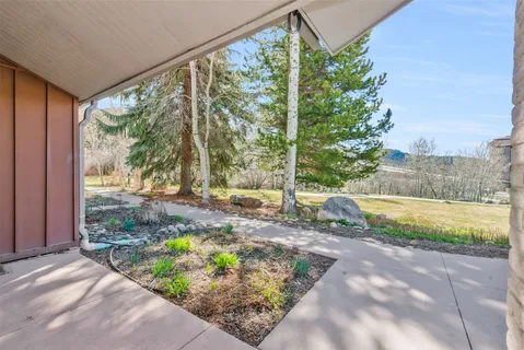 a view of a brick house with large windows and a outdoor space