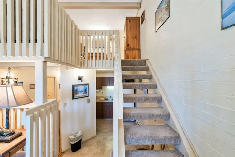 a view of staircase with white walls and windows