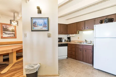 a kitchen with stainless steel appliances granite countertop a refrigerator sink stove and microwave