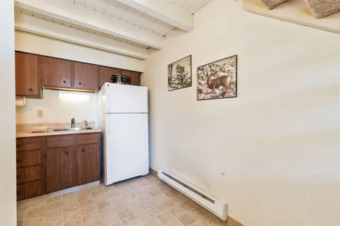 a white refrigerator freezer sitting in a kitchen