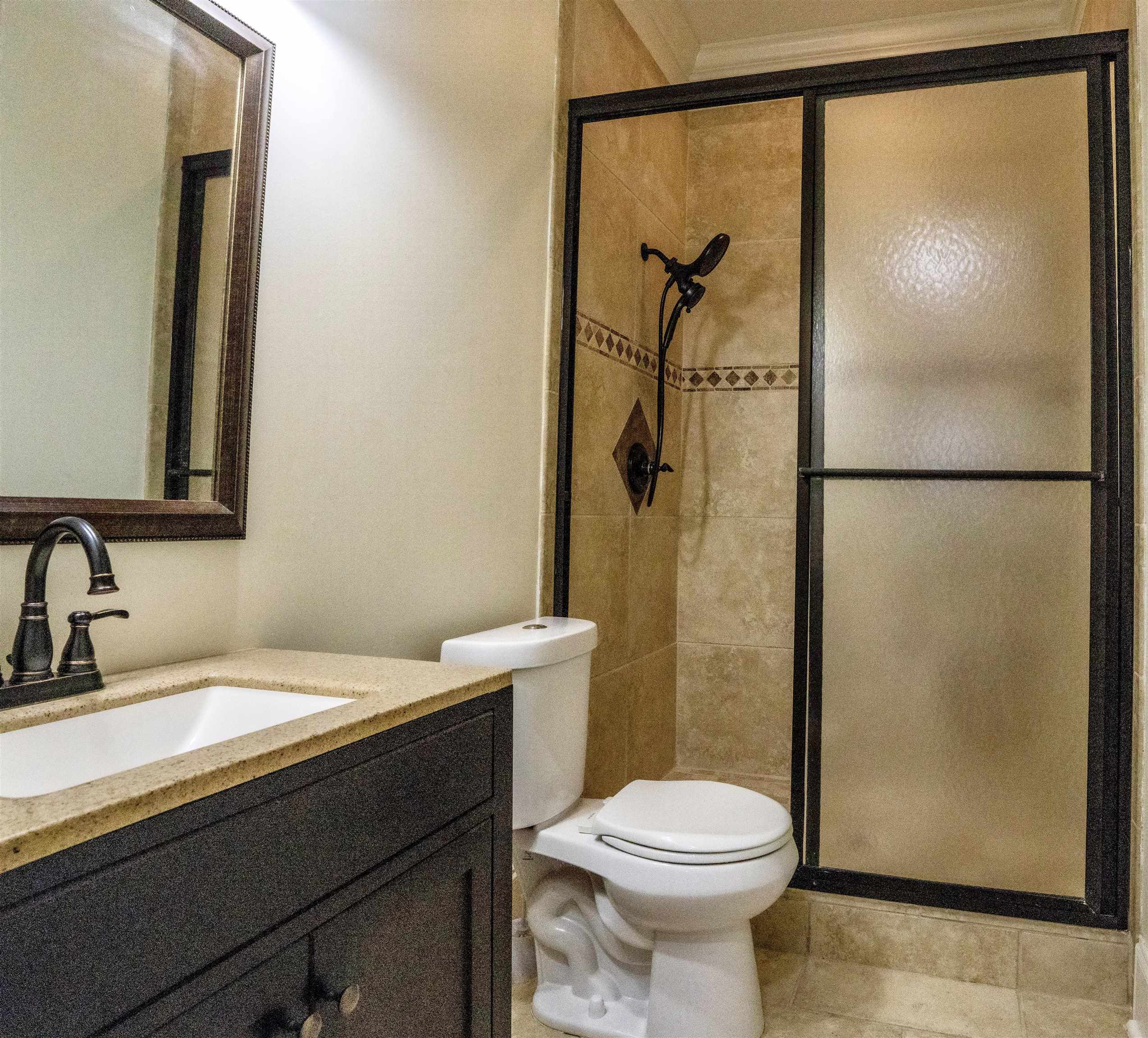 205 Jamerson Farm Road Collierville, TN 38017 - Photo 14 of 33 Bathroom featuring vanity, toilet, an enclosed shower, and tile patterned floors