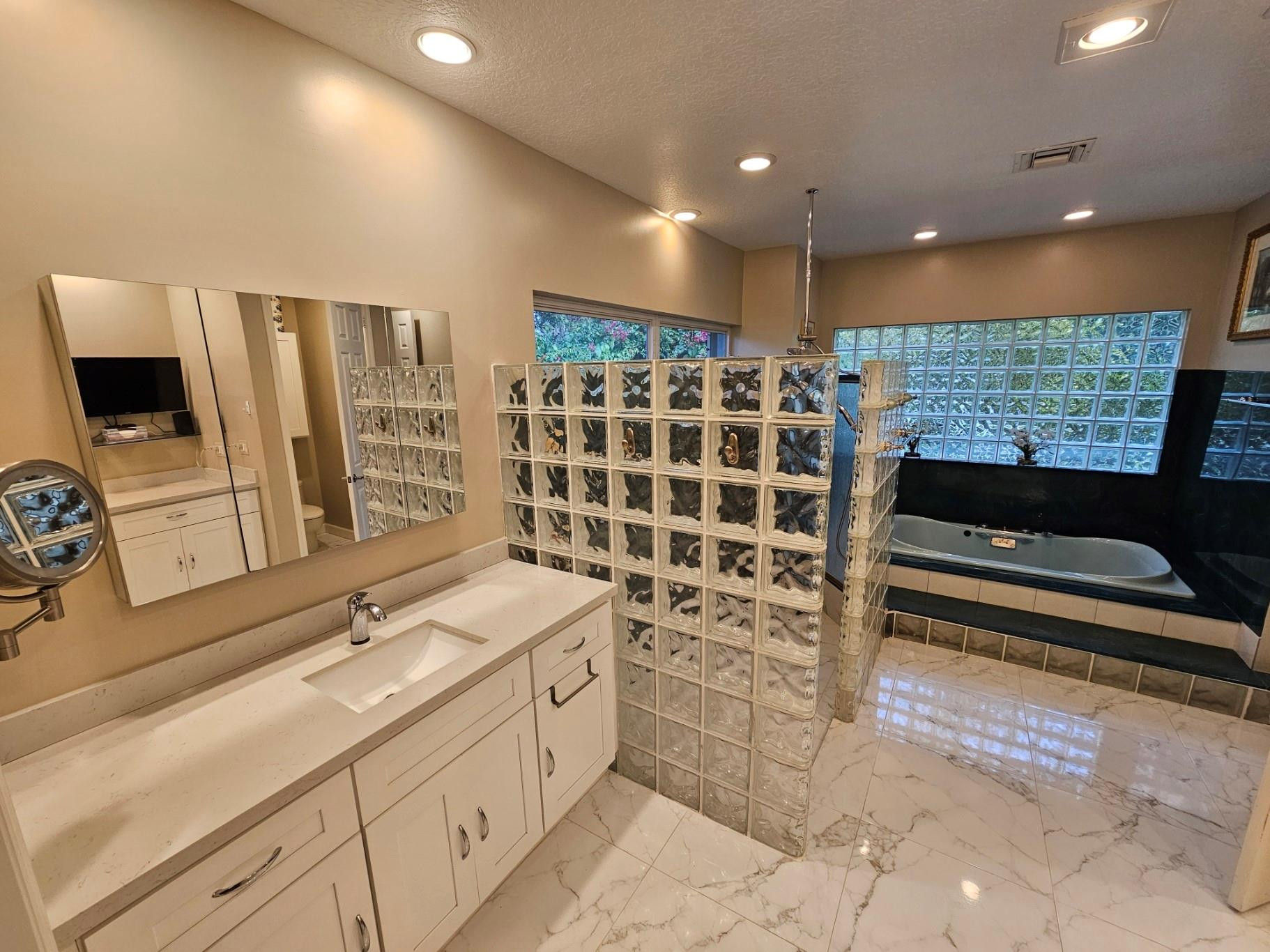 6963 Wilson Road West Palm Beach, FL 33413 - Photo 14 of 29 a bathroom with double vanity and a bathtub